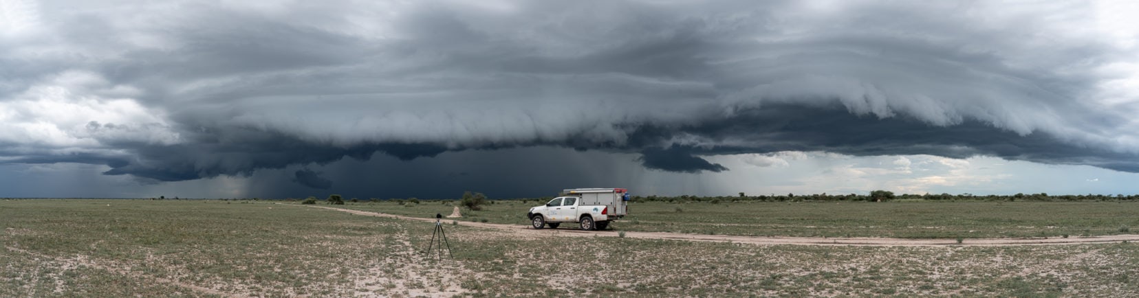 Driving in Nxai pans - camper with storm clouds in distance