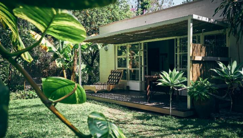 Entrance to the accommodation at Maun studios showing terrace and lush garden