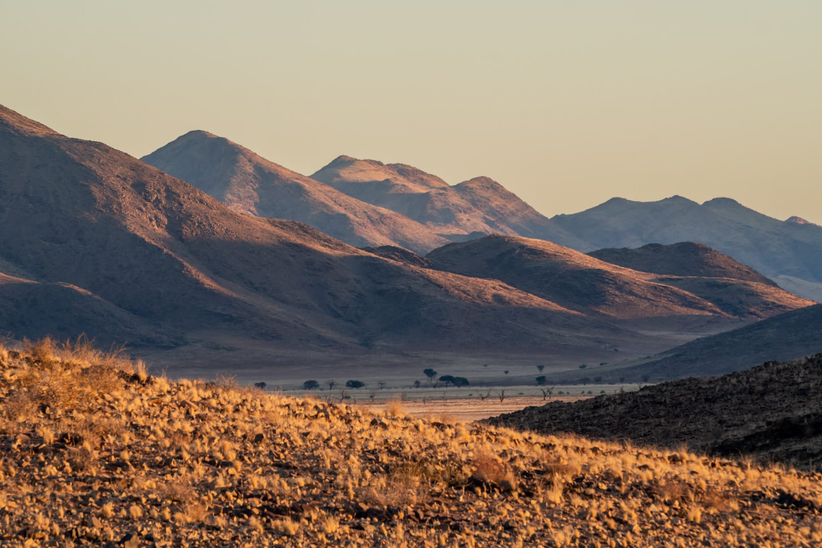 sunrise shot of mountains and desert plain at Kanaan Desert retreat