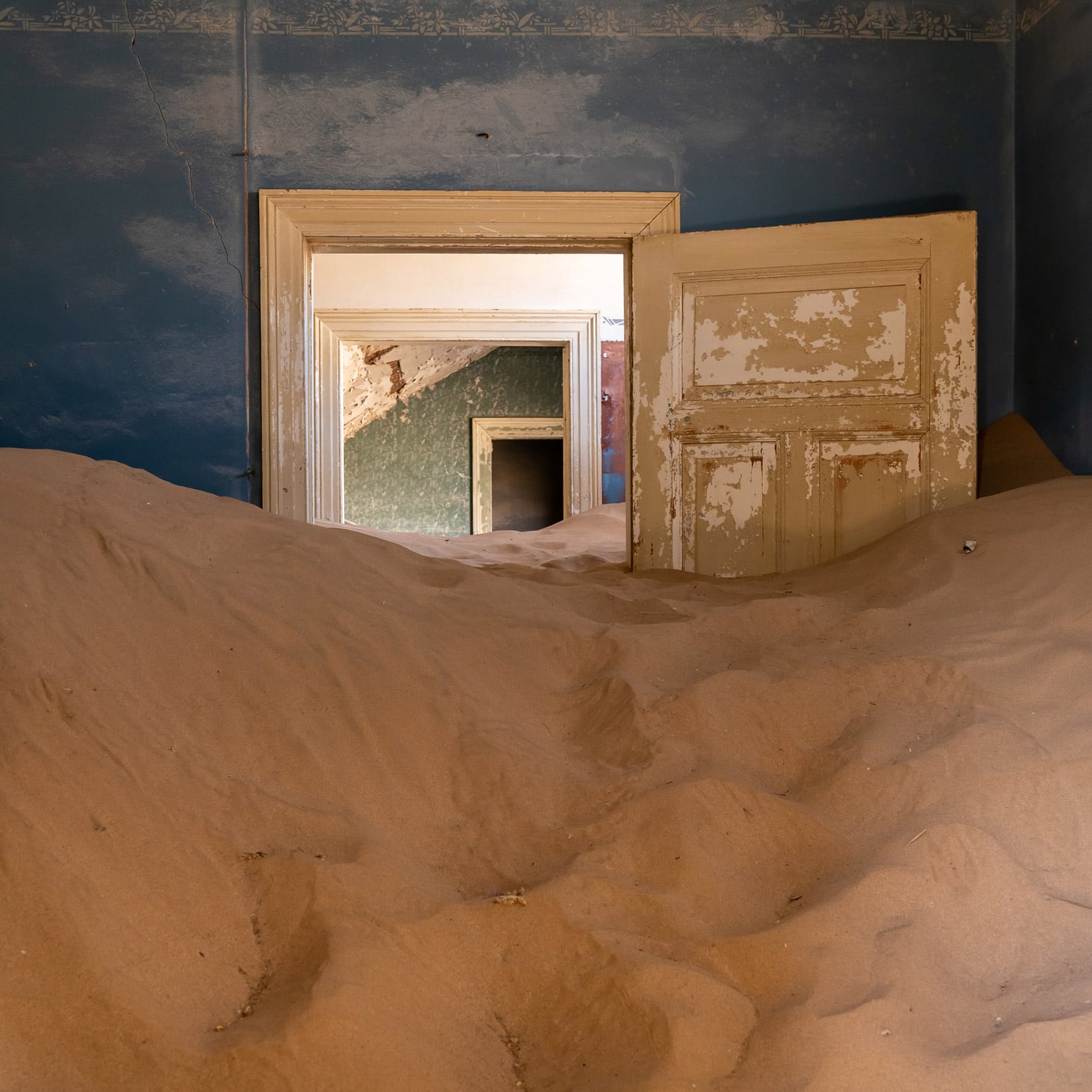 Doorway almost covered with sand at Kolmanskop