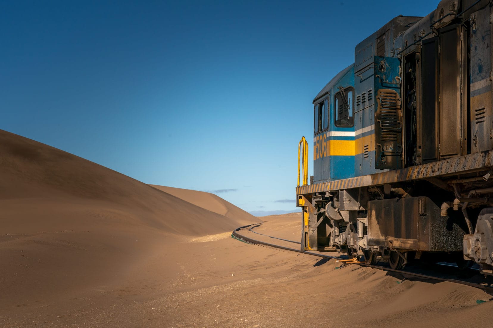 Abandoned train on road to Luderitz with a leading line track 