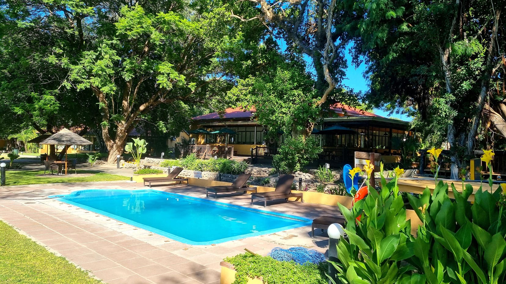 Cresta-riley-hotel-maun with swimming pool and lush gardens