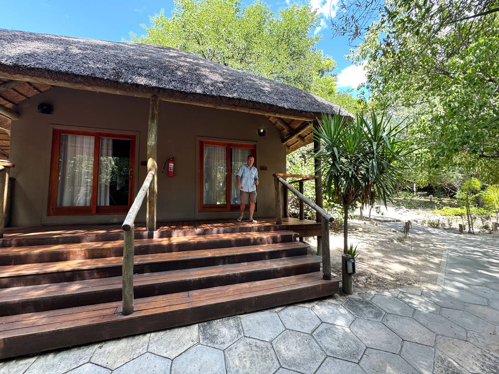 Wooden steps leading to double doors with lars stood outside 