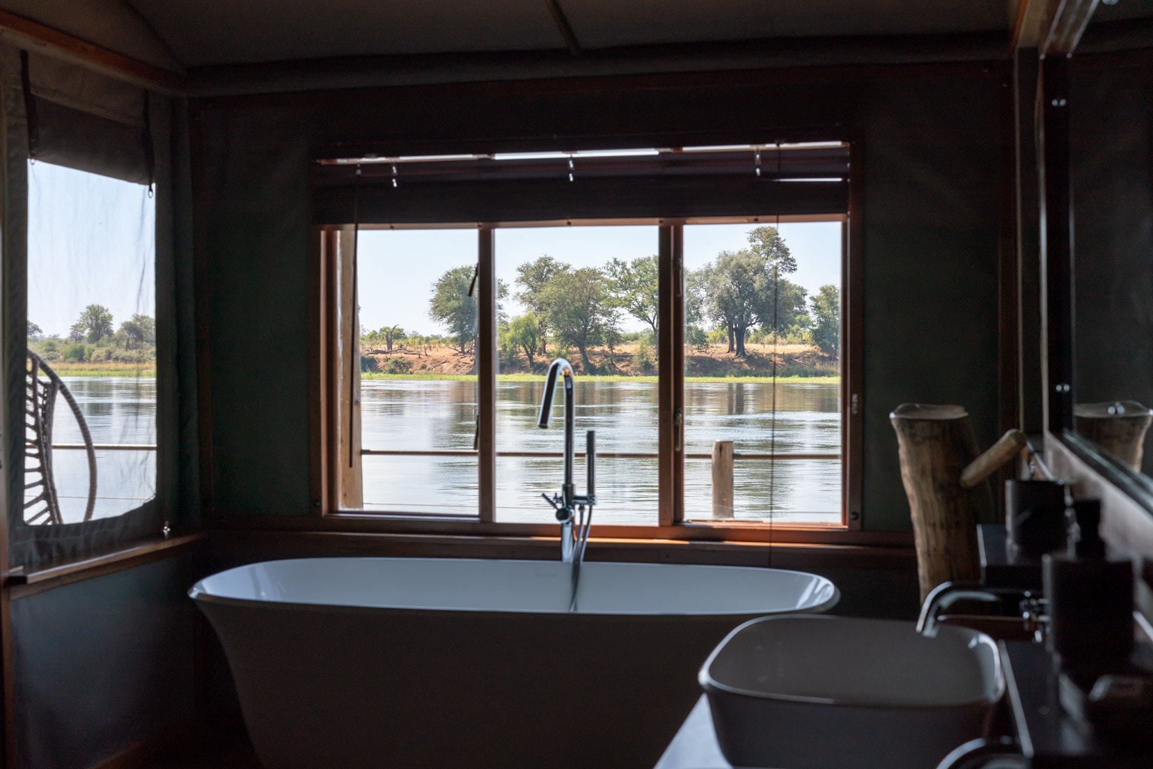 View of the bath tub and view out onto the river from the river suite at Ndhovu Safari Lodge 