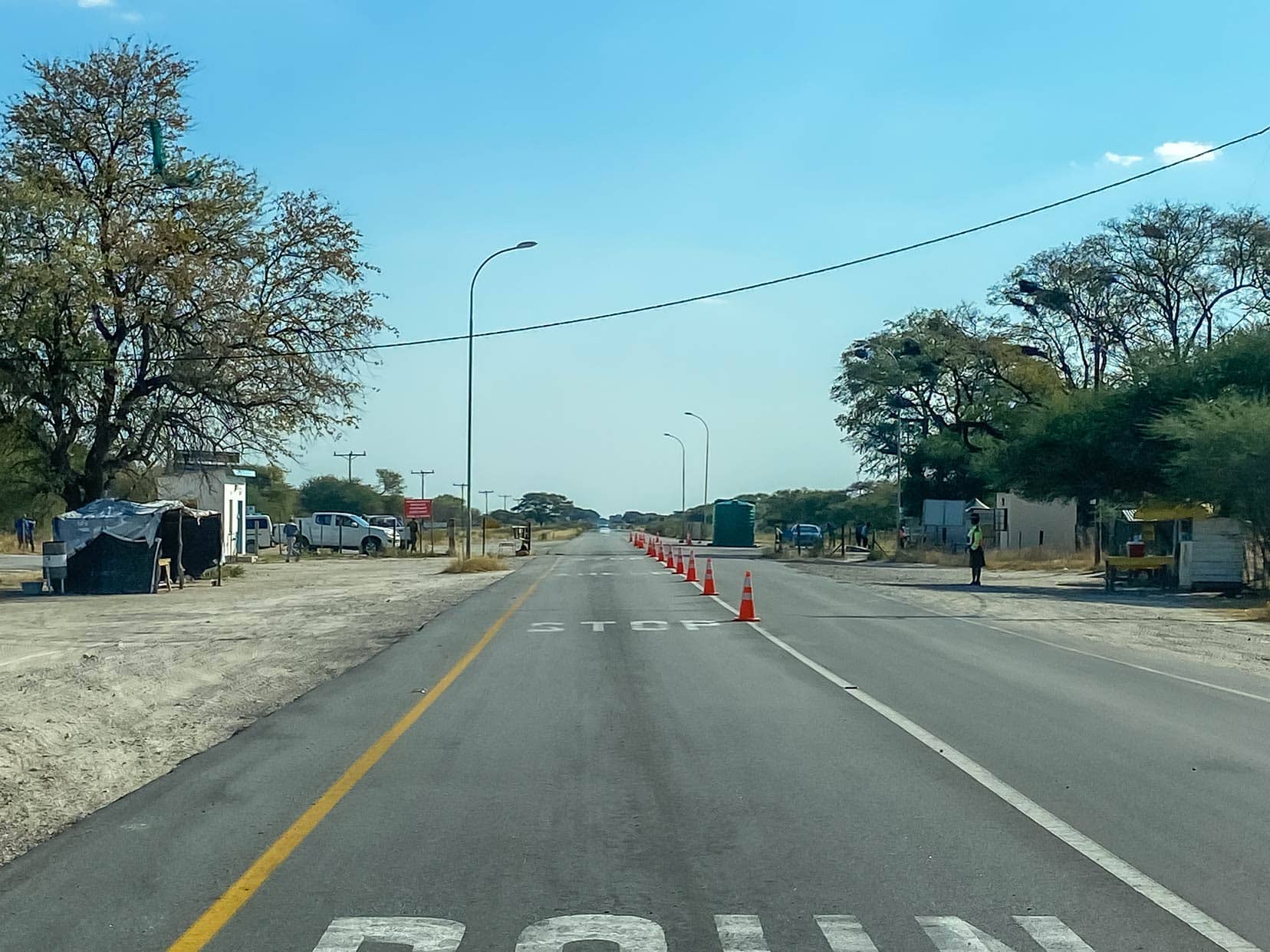 road block with an officer standing beside the road