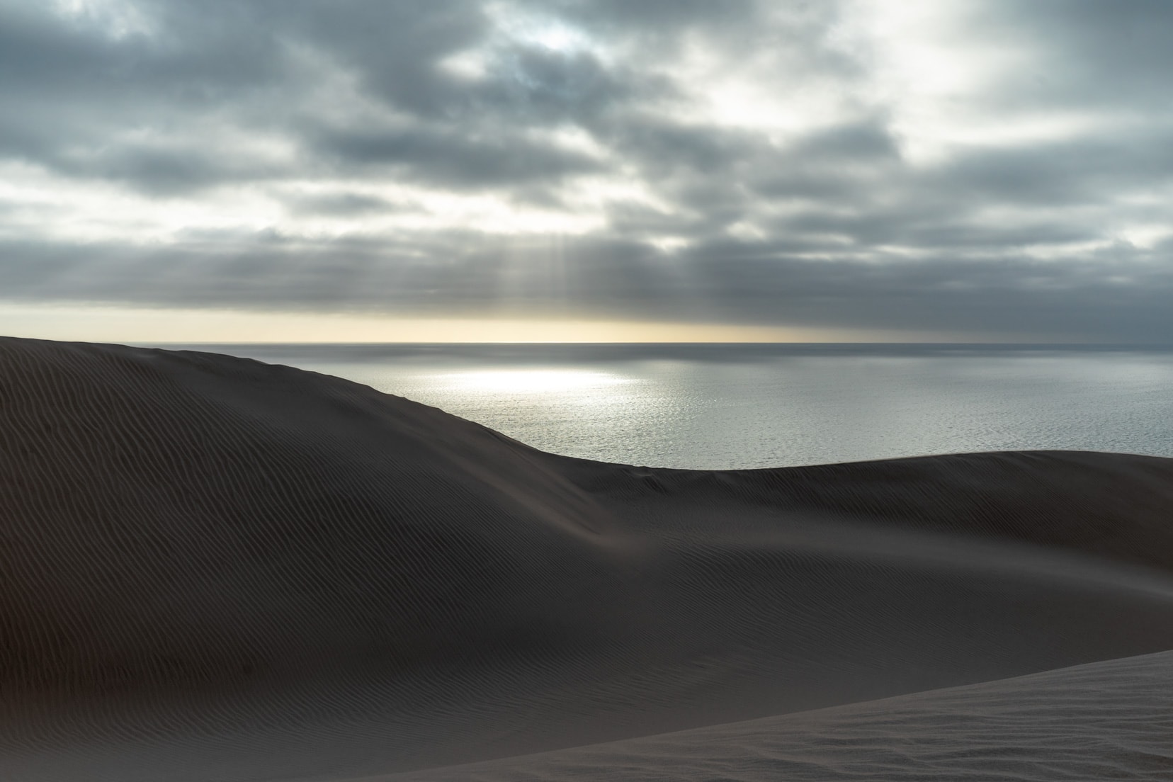 Blue-sand-dune-and-water-plus-sunlight