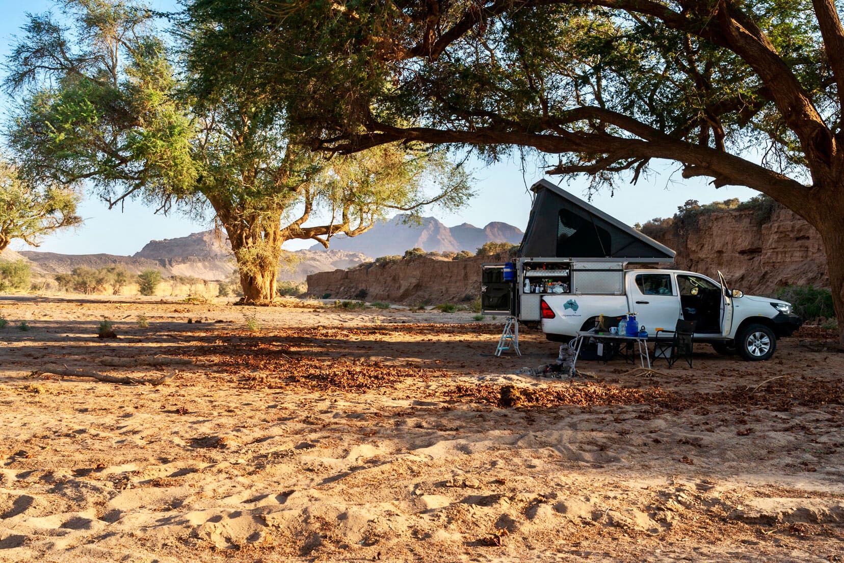 Our 4x4 hilux with tent popped up on top in the sandy gorge in namibia