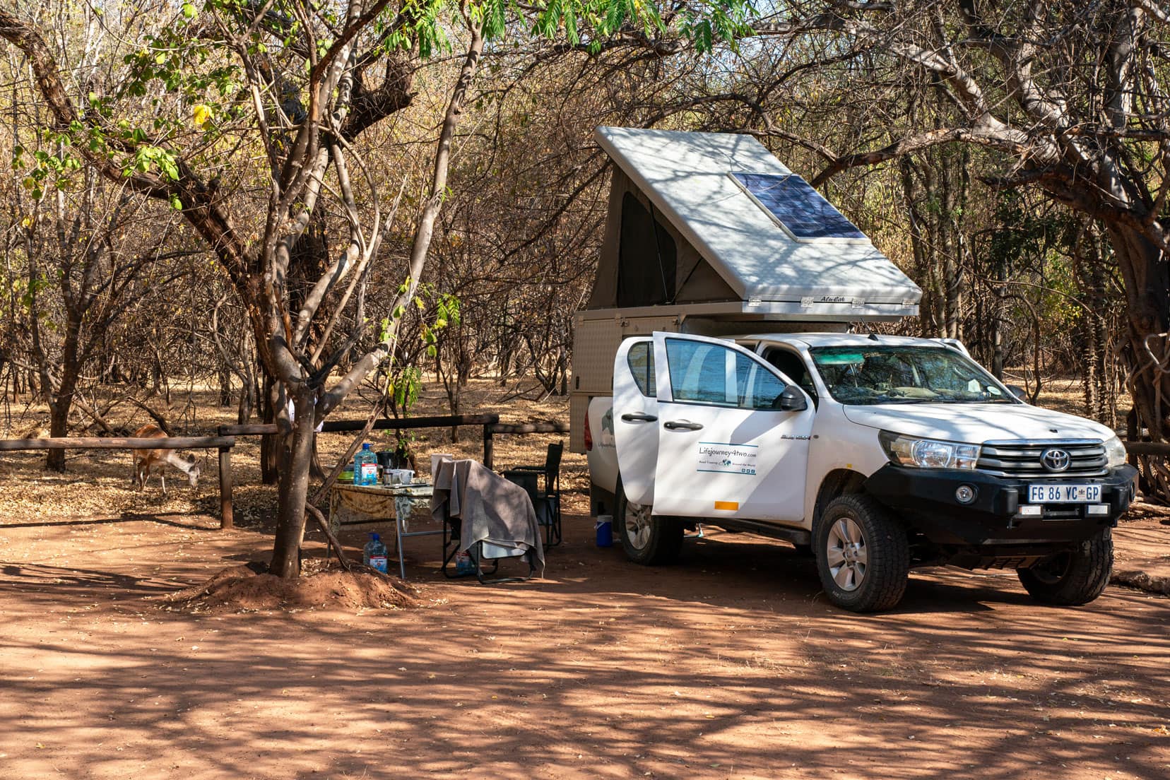 4x4 bush camper with pop up tent in a campsite in Botswana