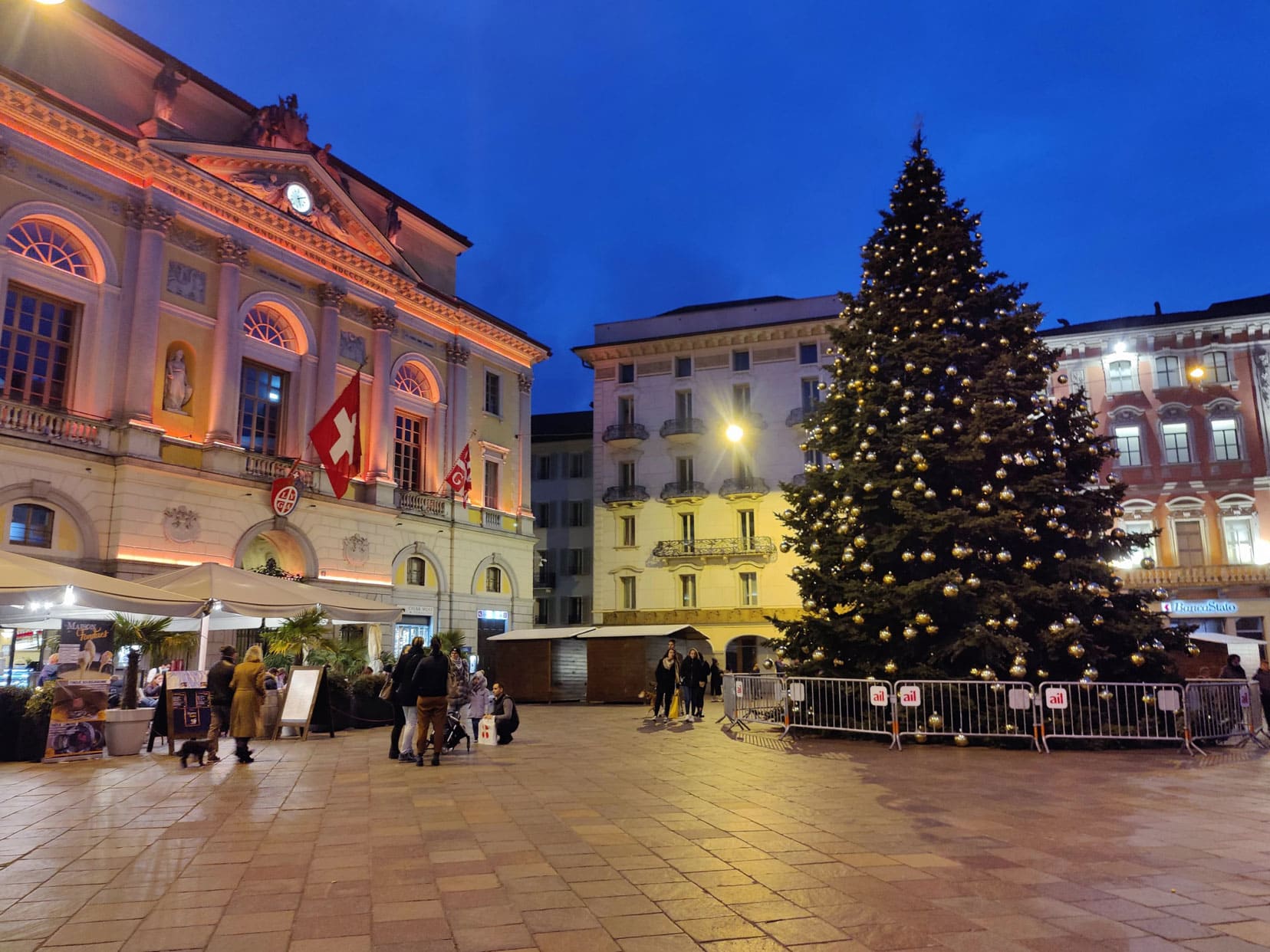 Christmas tree in Lugano in an open square surrounded by buildings