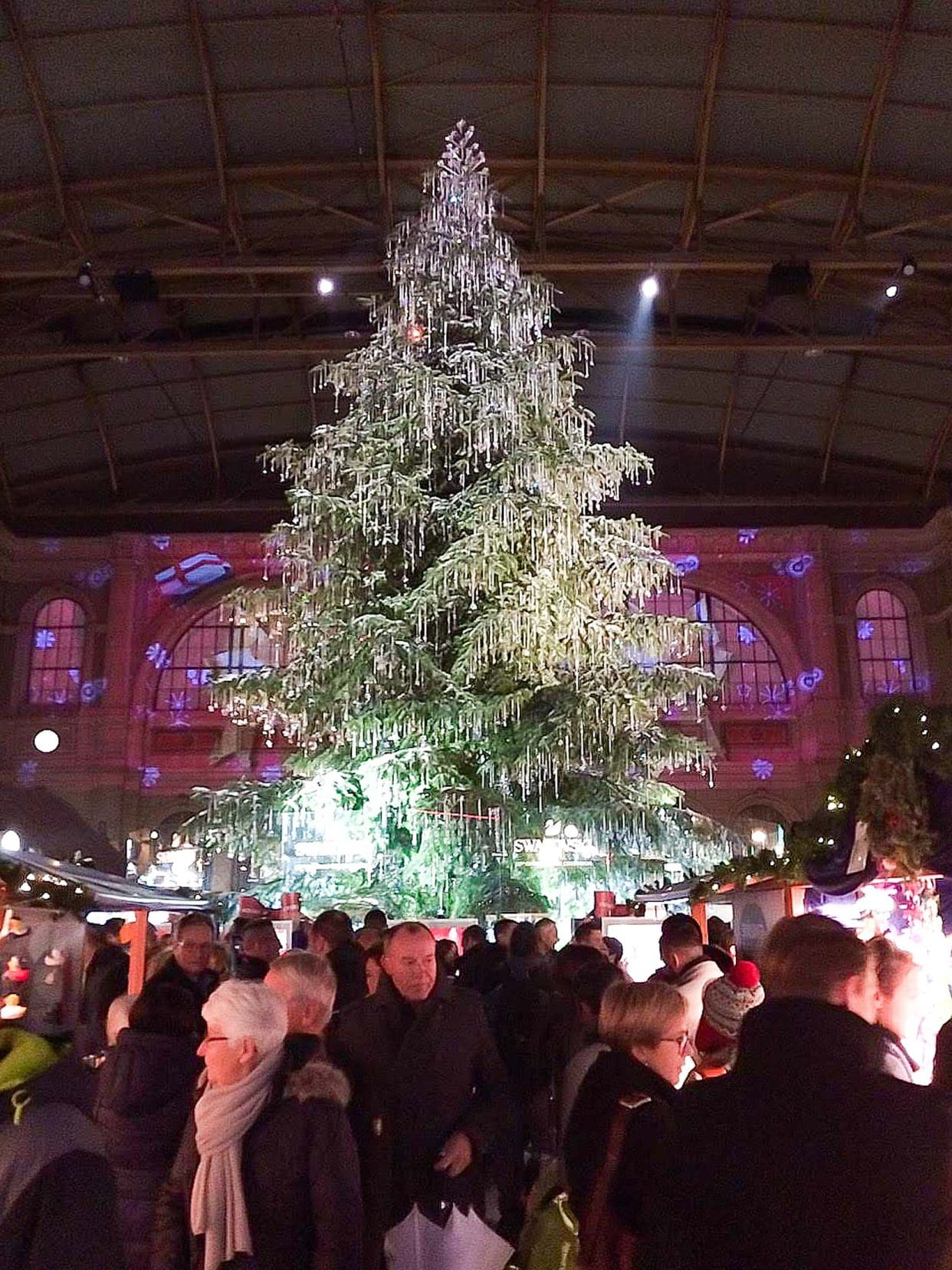 large christmas tree in the iddle of Zurich Centrl station Christmas market - adorned with shimmering crystals