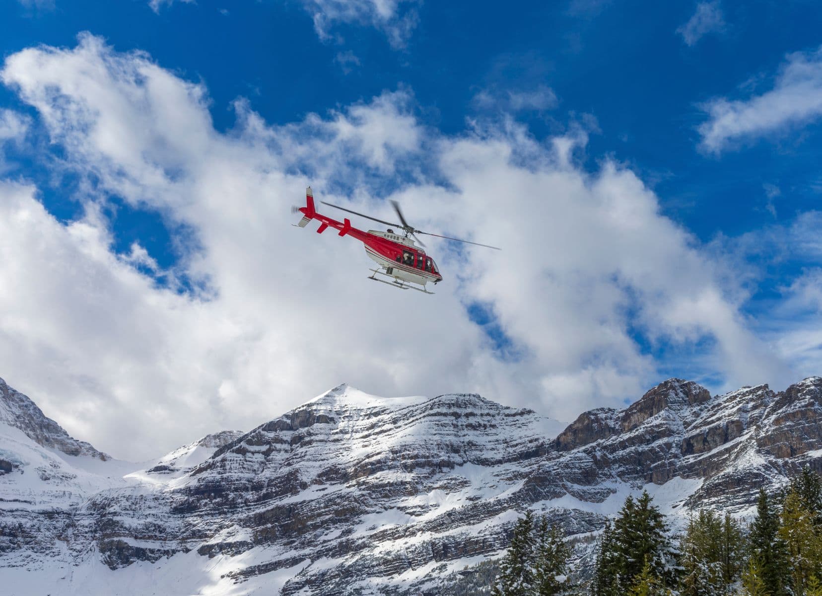 Helicopter in the sky above high mountains