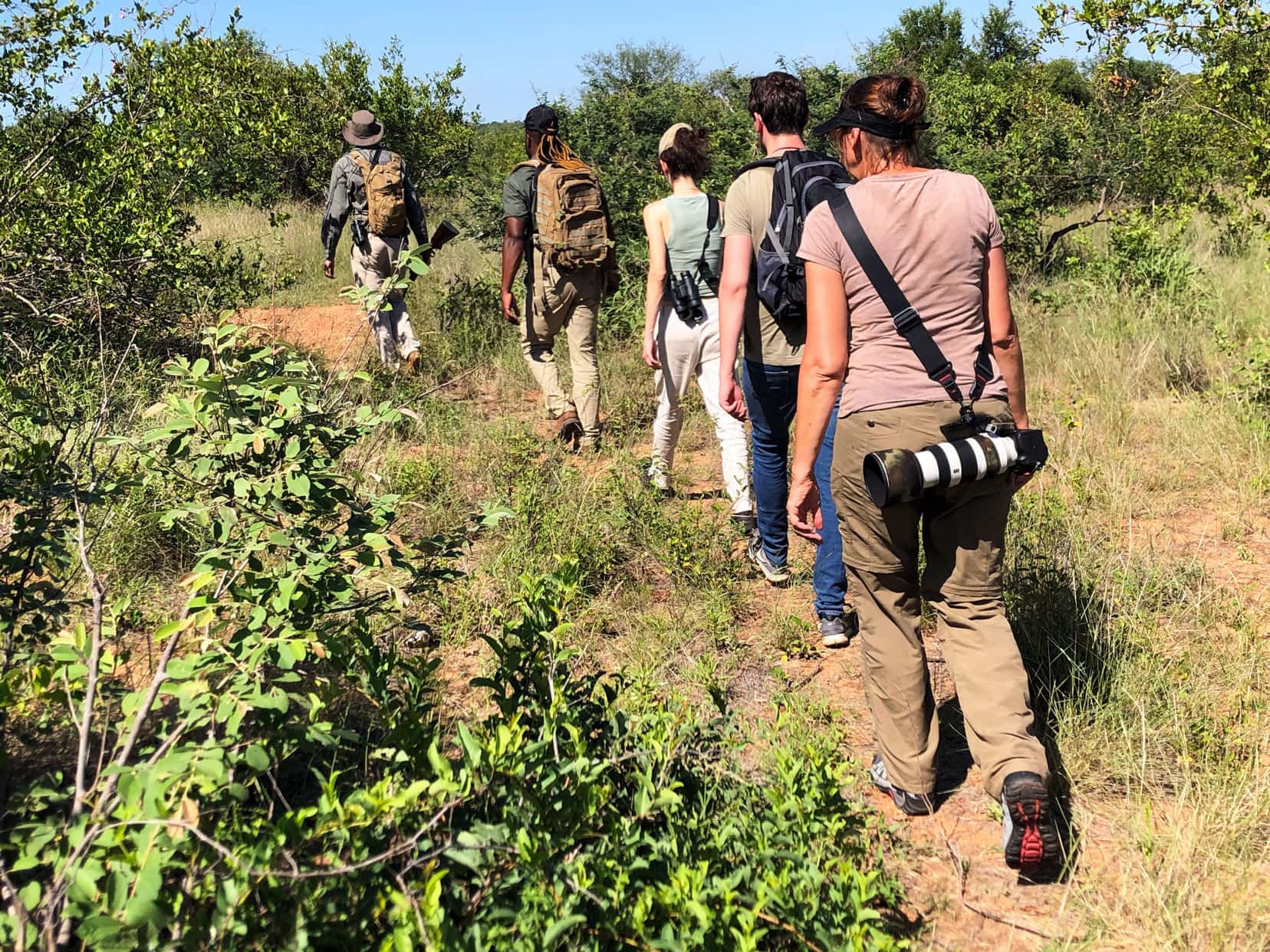 row of people walking in single file, with Shelley at the rear, on a walking safari in Klaserie Private Nature Reserve