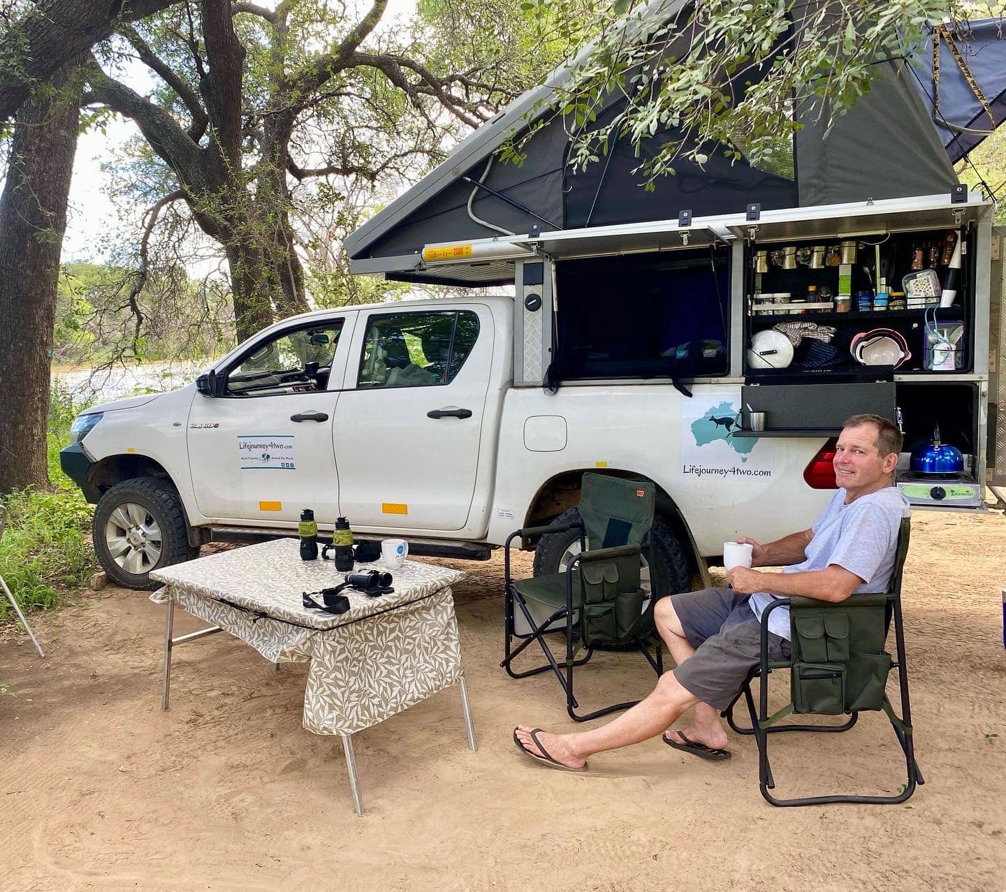 Lars sat by our bush camper with the tent popped up