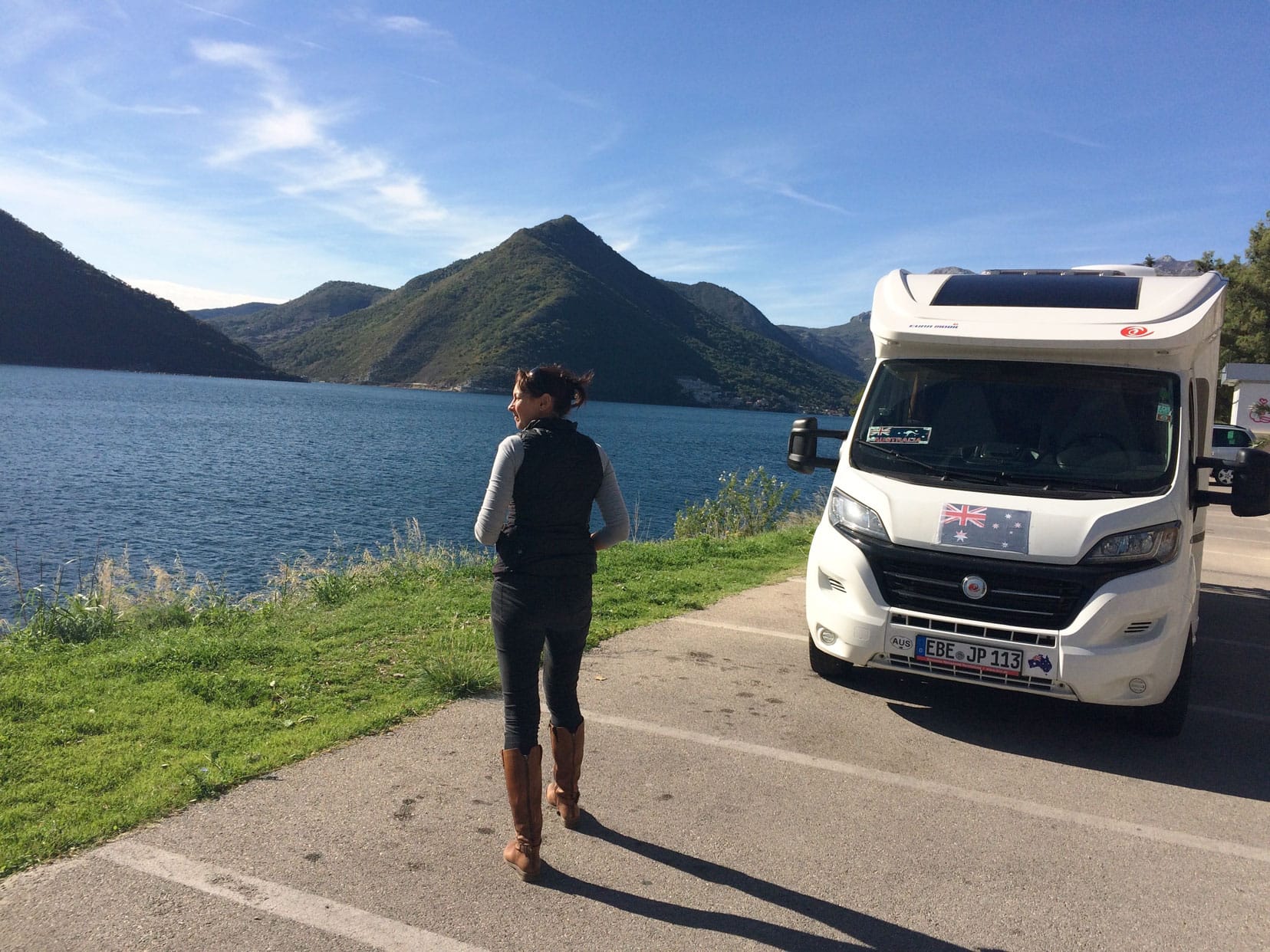 Shelley looking out to a lake by the motorhome 