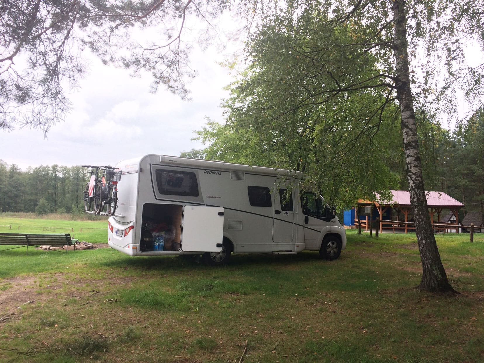 Motorhome with side back storage door open and bikes on the back in a bike rack