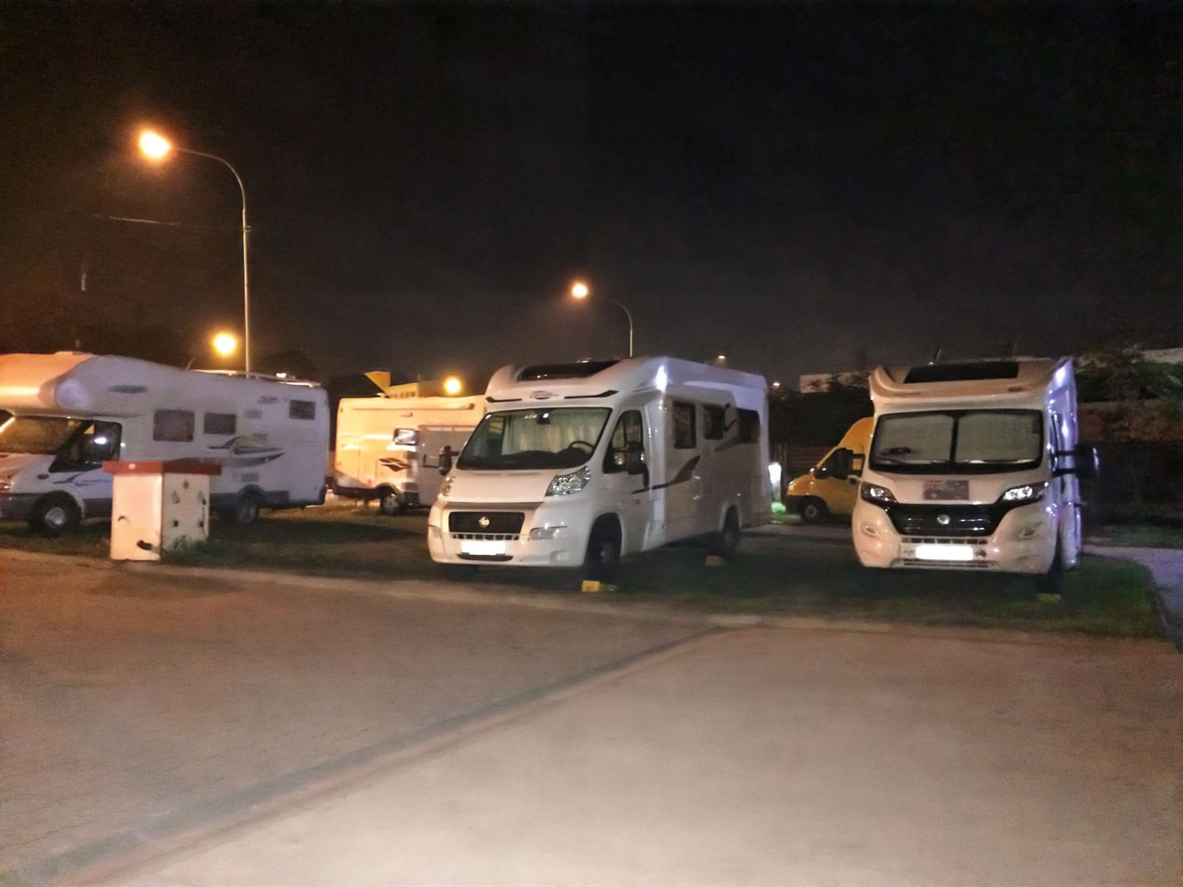 Motorhomes parked up in a camp at night