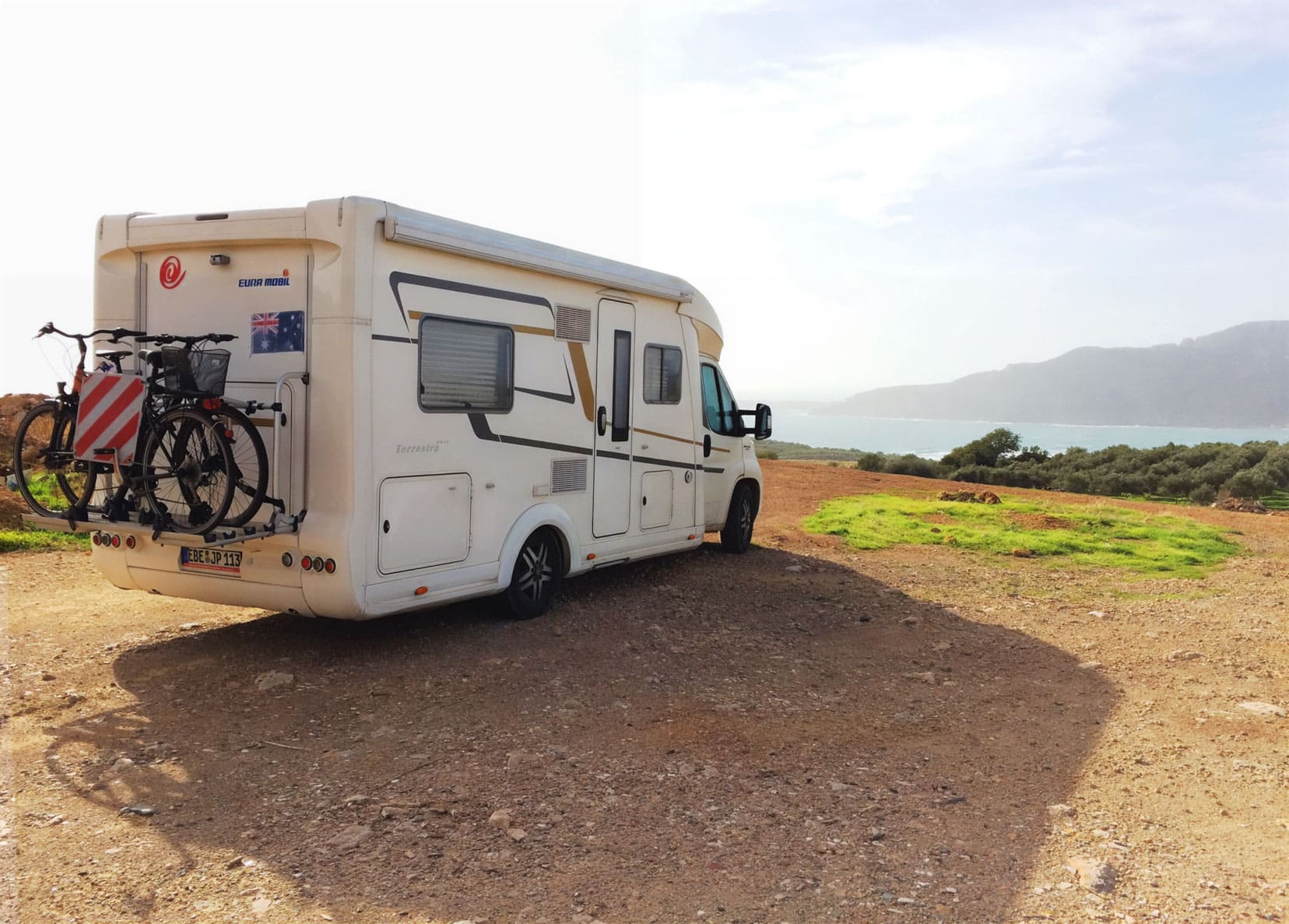 motorhome parked looking at ocean and mountains