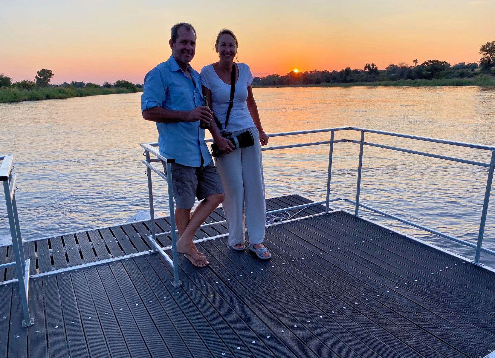 Shelley and Lars on a boat with the sunsetting behind them