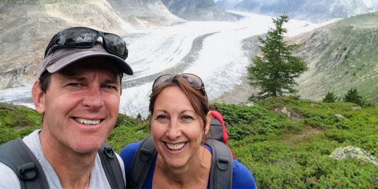 Travel tips for couples feature image of shelley and Lars by a glacier in Swiss Alps