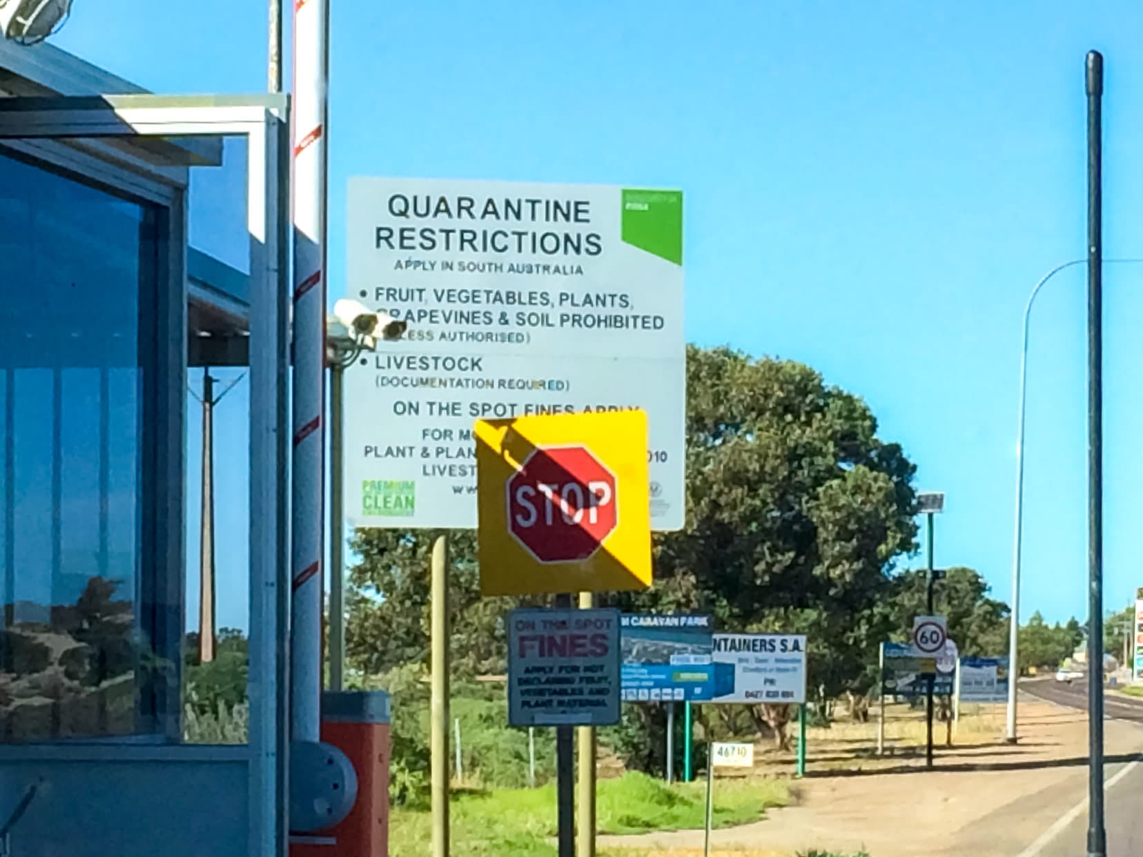 Photo of the quarantine border crossing with lots of signs by the side of the road 