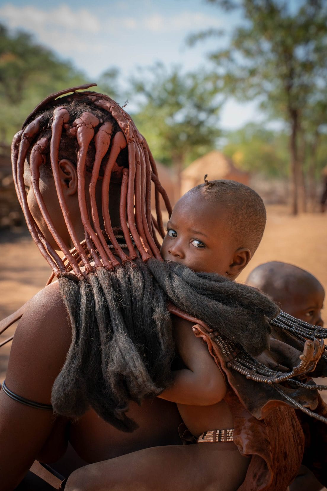 Himba child with mother, Hoarisib River