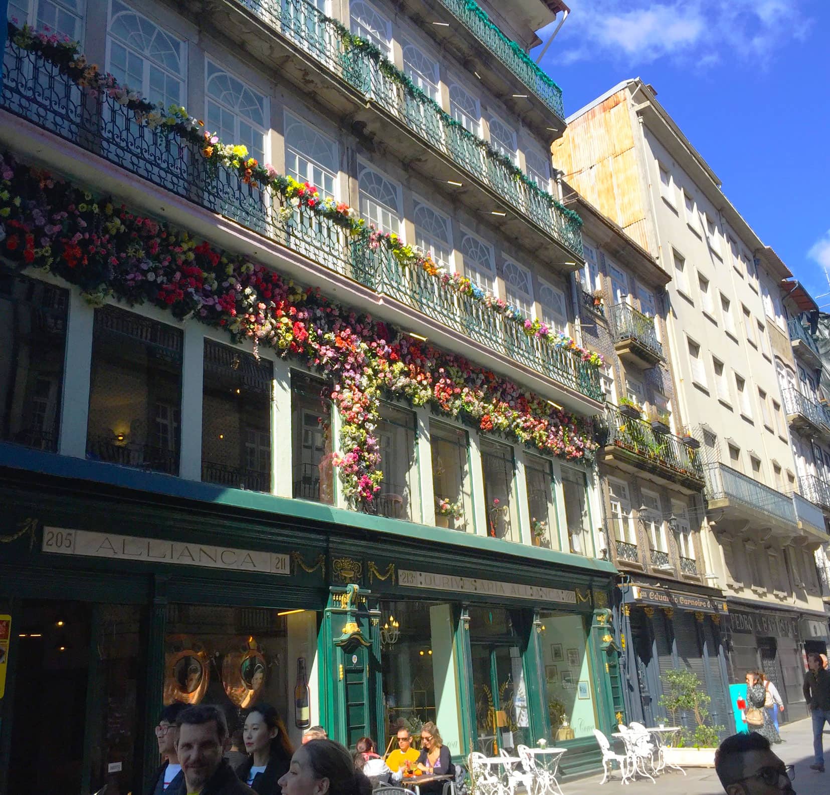 Shops with lots of flowers on the facade