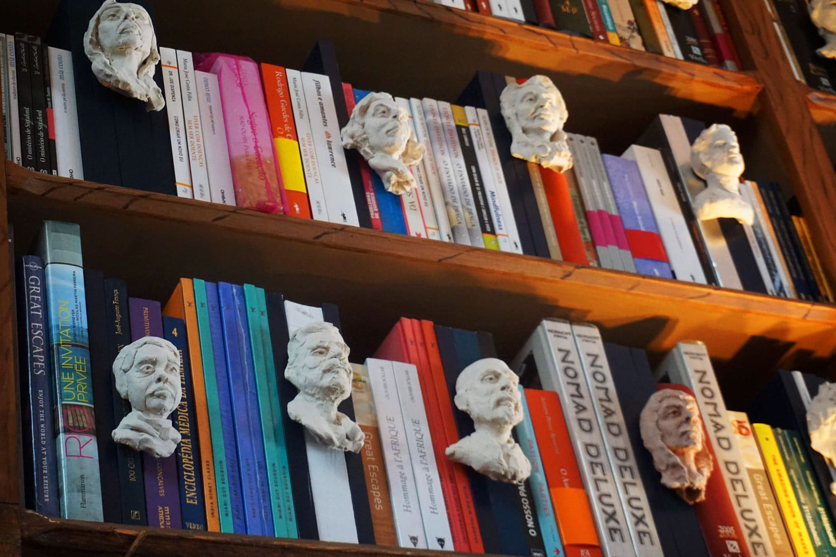 livraria Lello bookshop shelves with small white heads on the books