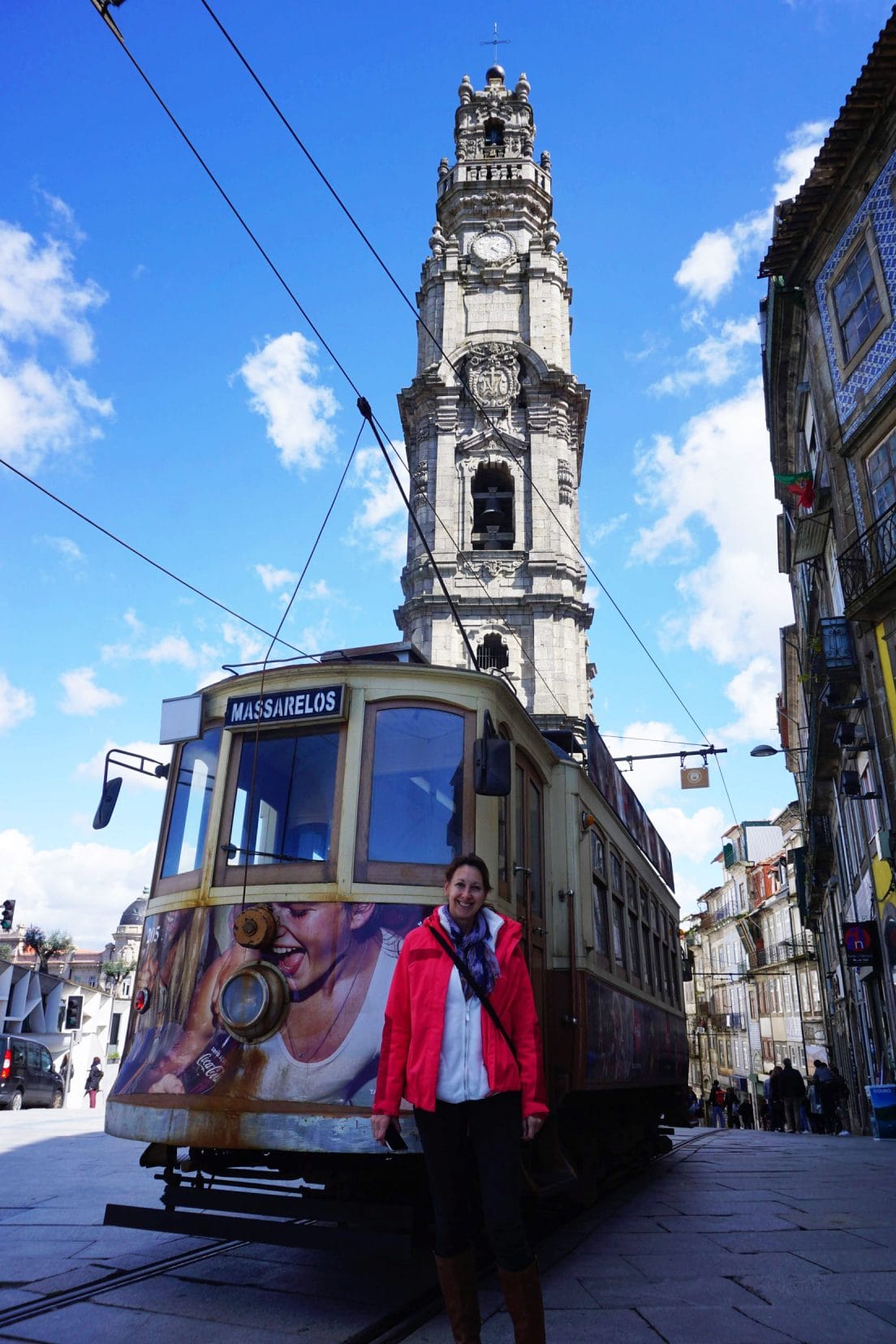 Shelley stood by the Clerigos tower church and a tram in Porto