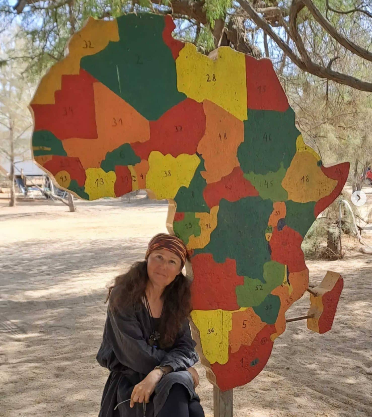 Anna-by-a-map-of-Africa-hanging from a tree 