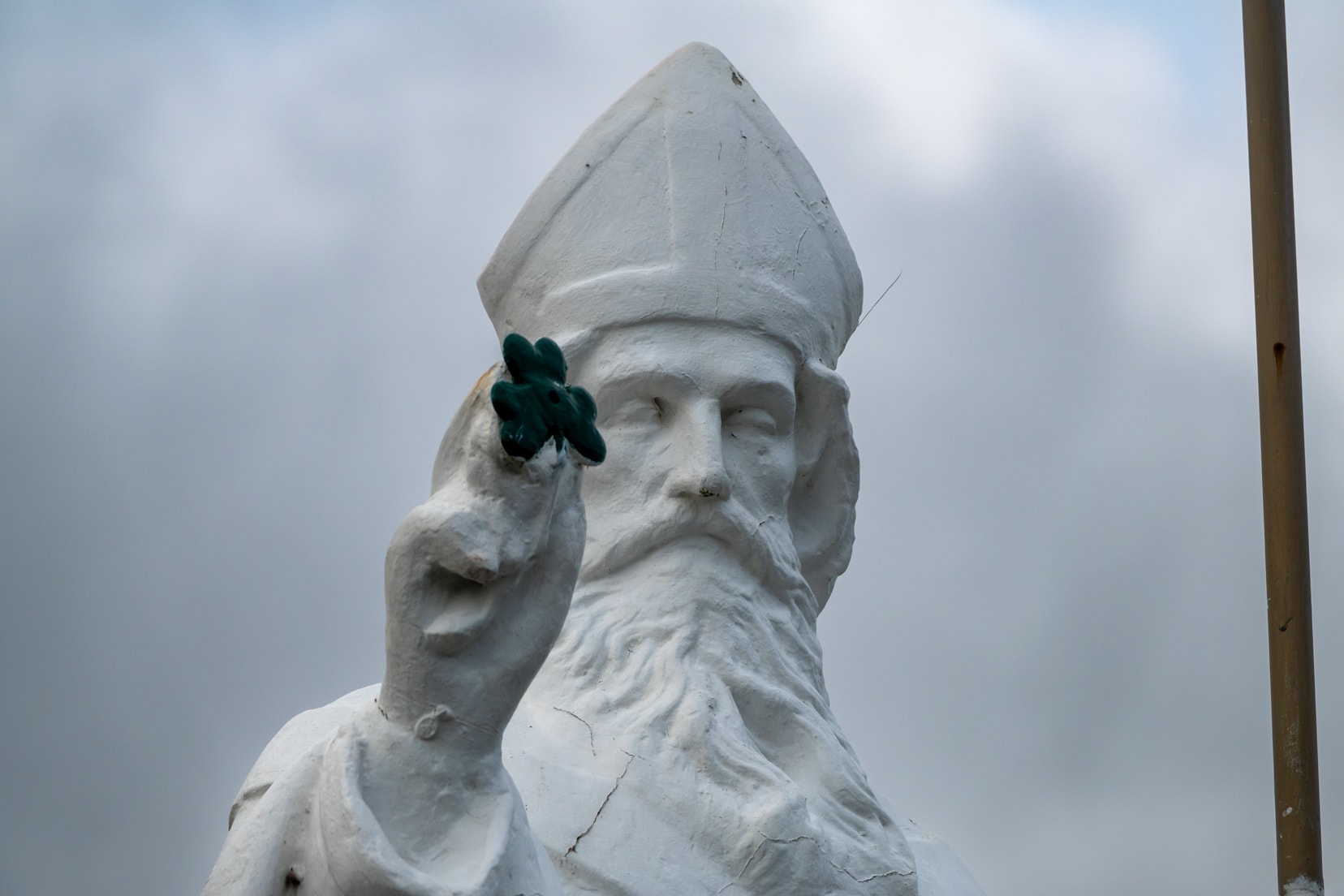 Croagh-Patrick-statue-of-St-patrick holding a green 4 leaf clover