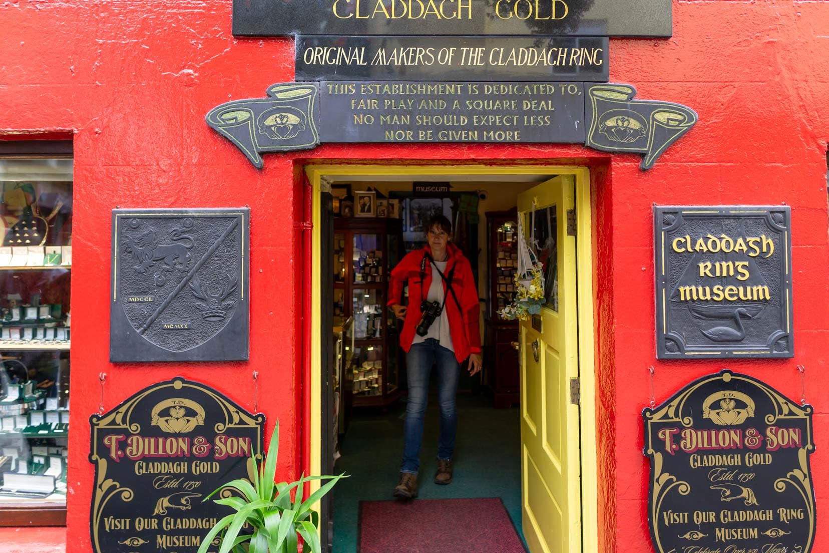 Shelley stood in doorway of red painted building with historical plaques about the claddagh ring