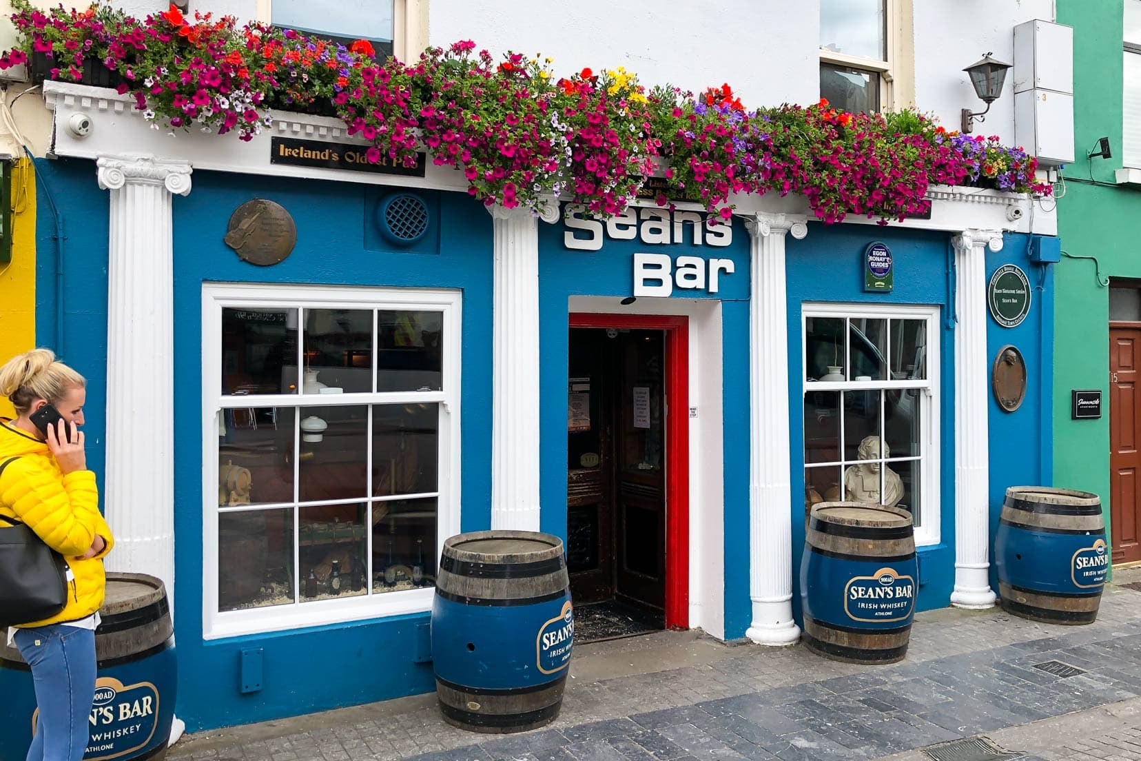 Seans bar facade on the outside - blue walls and flowers above the sign
