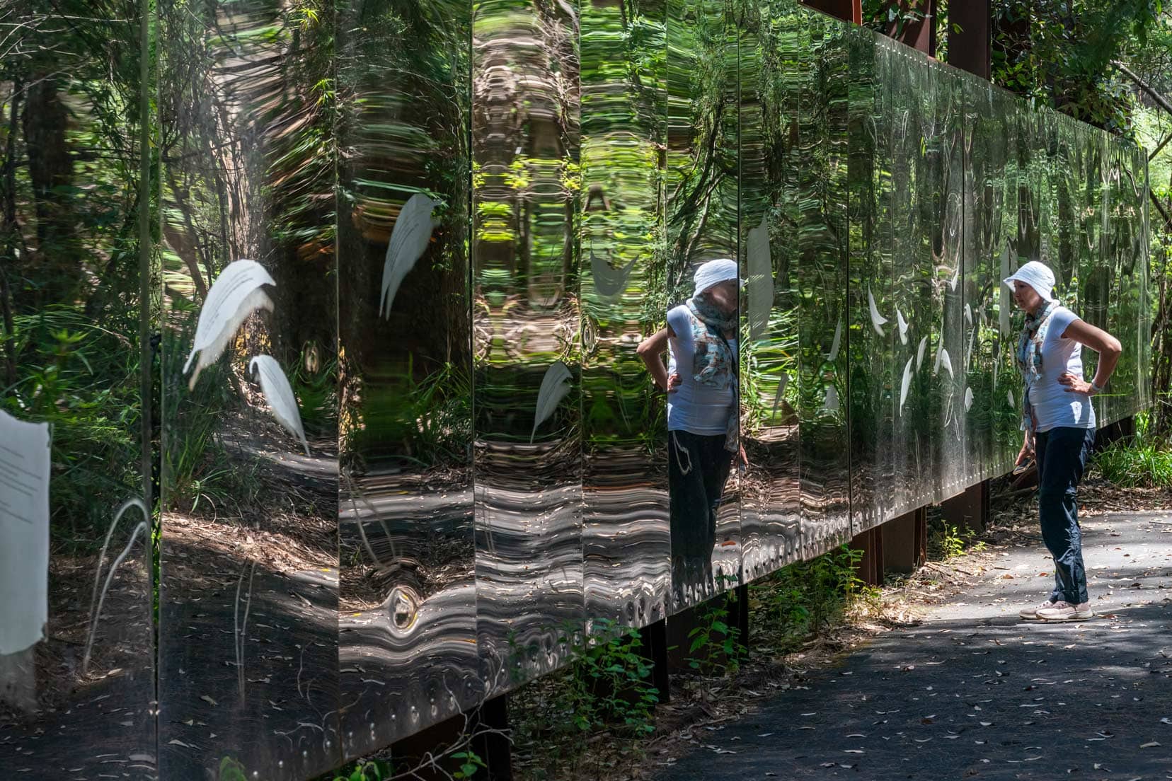 Shelley stood in front of the mirrored wall at Swarbrick art Loop with reflections of the forest 