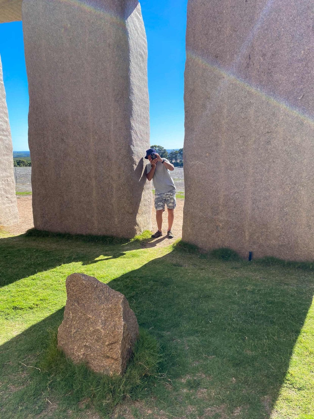 Lars taking photos between the stones at Esperance stonehenge