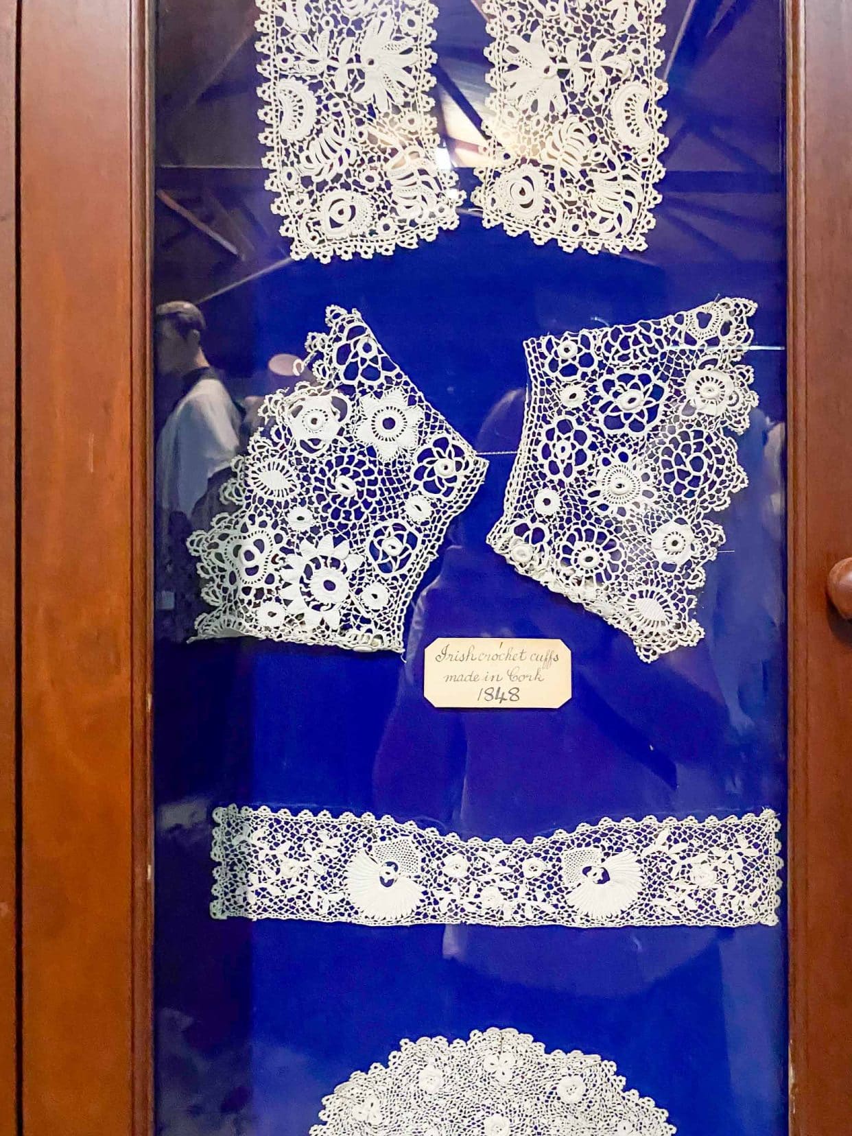 wooden Display showing lace designs on blue felt