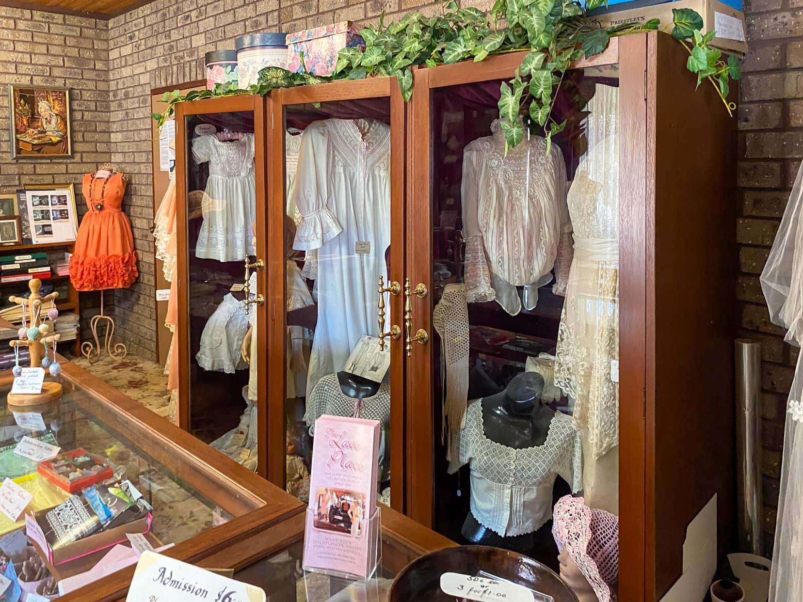 Perth to Wave Rock Lace-Museum-with hanging dresses in a cabinet