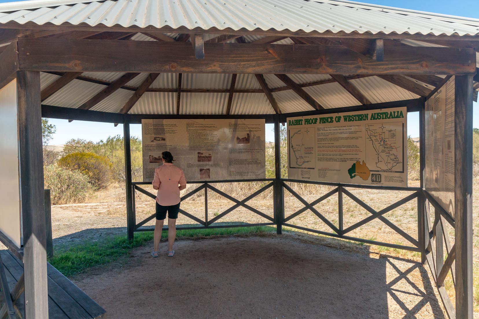 Shelley stood in the Rabbit-Proof-Fence-info-board and gazebo