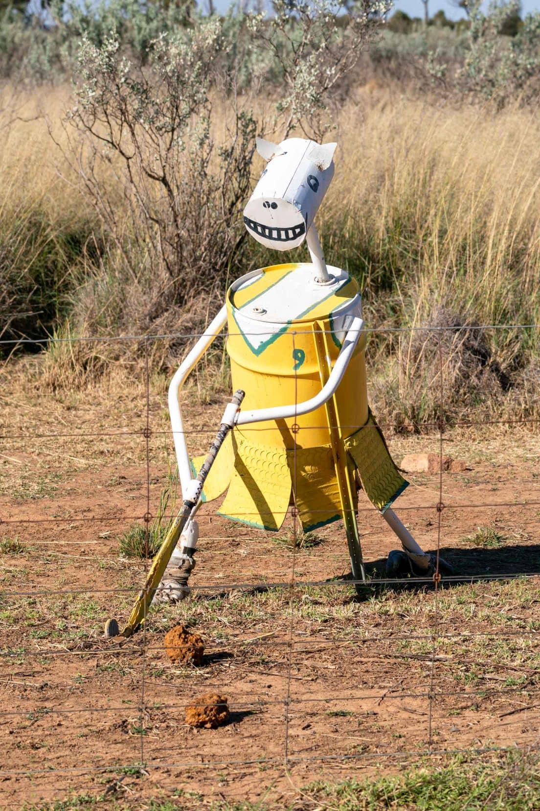 White tin horse dressed in yellow gym gear playing hocky