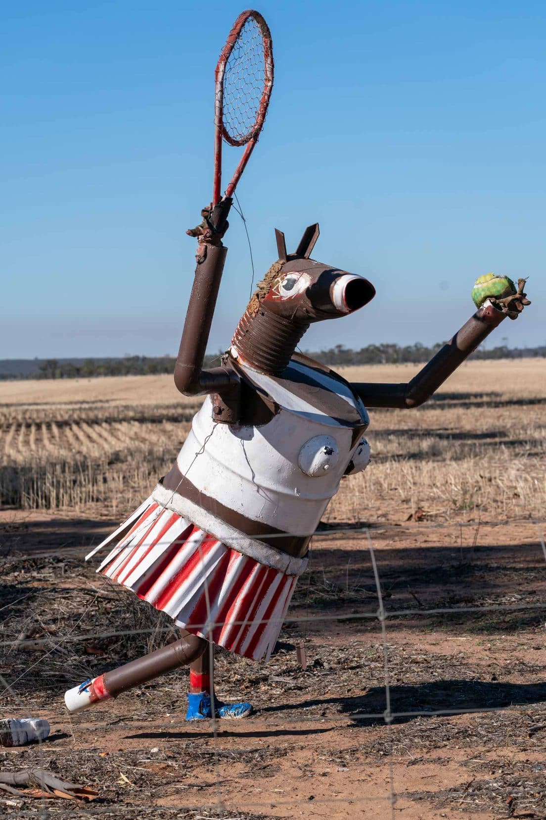 Tin horse in tennis gear with raquet and ball
