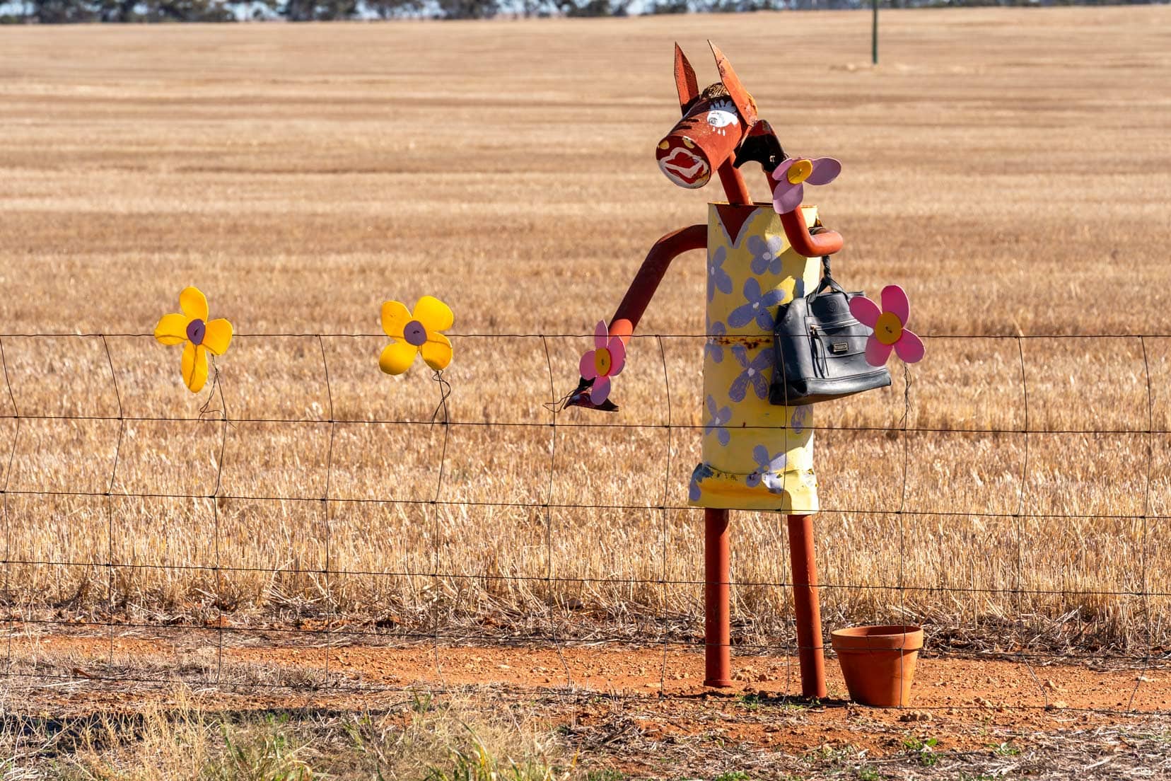 Tin-horse-highway-Kulin horse in a daisy dress with flowers on the fence and gardening