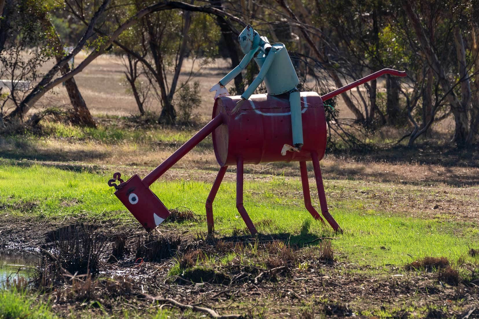 Tin Horse with rider and horse is eating grass