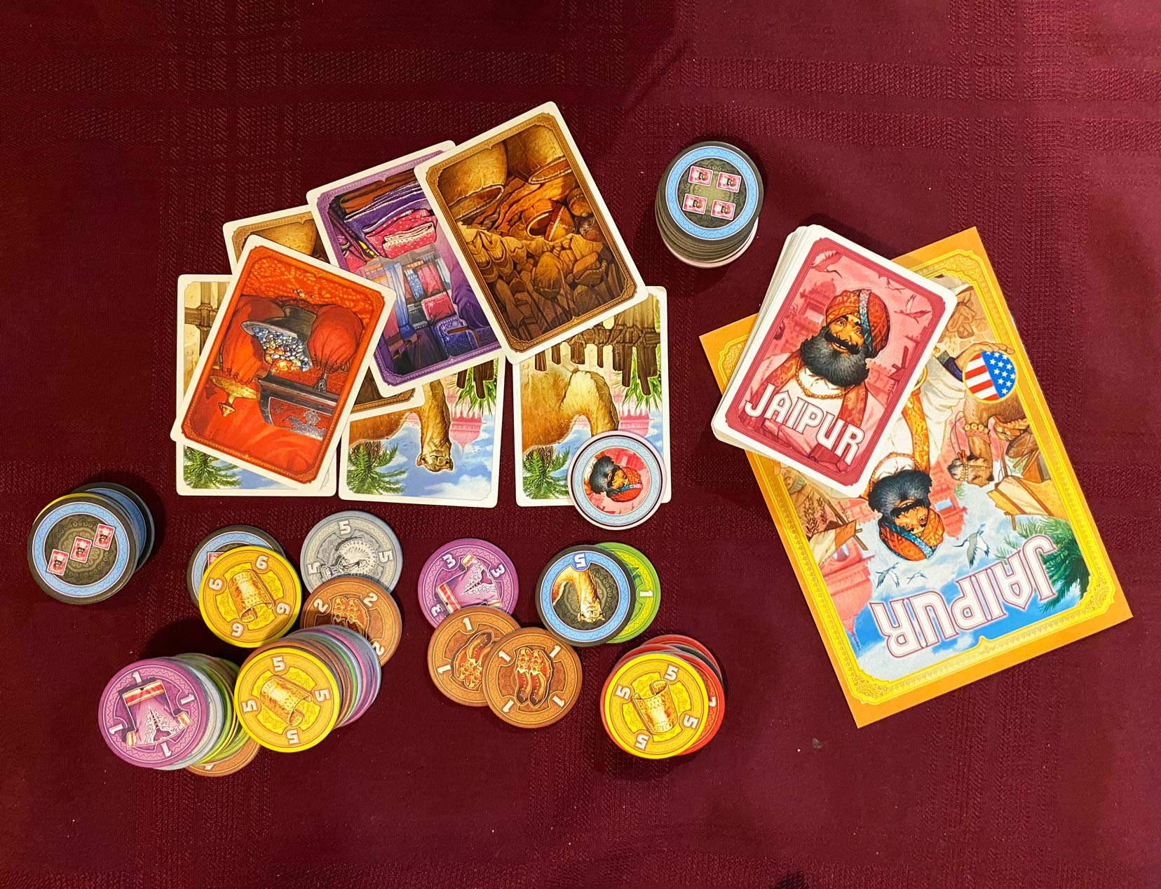Jaipur game set up with cards, money tokens 