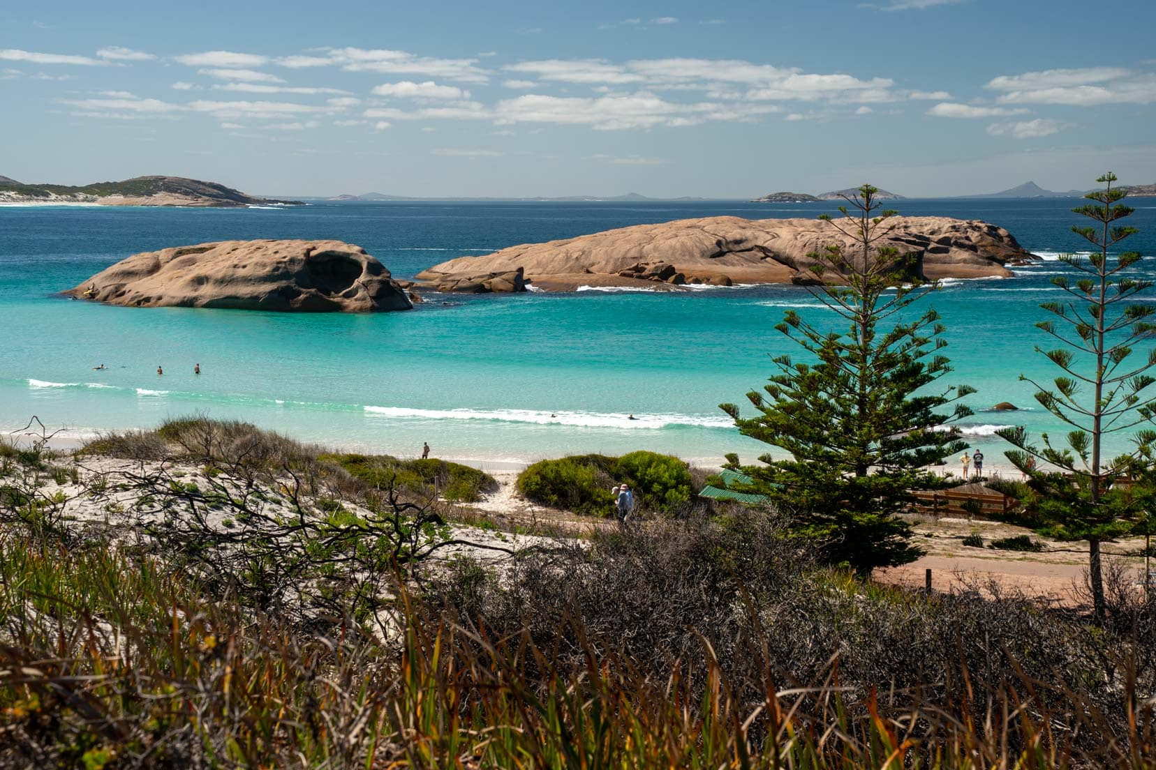 Twilight Beach in Esperance Turquoise ocean with large granite rocks near the shore with bushland in the foreground 