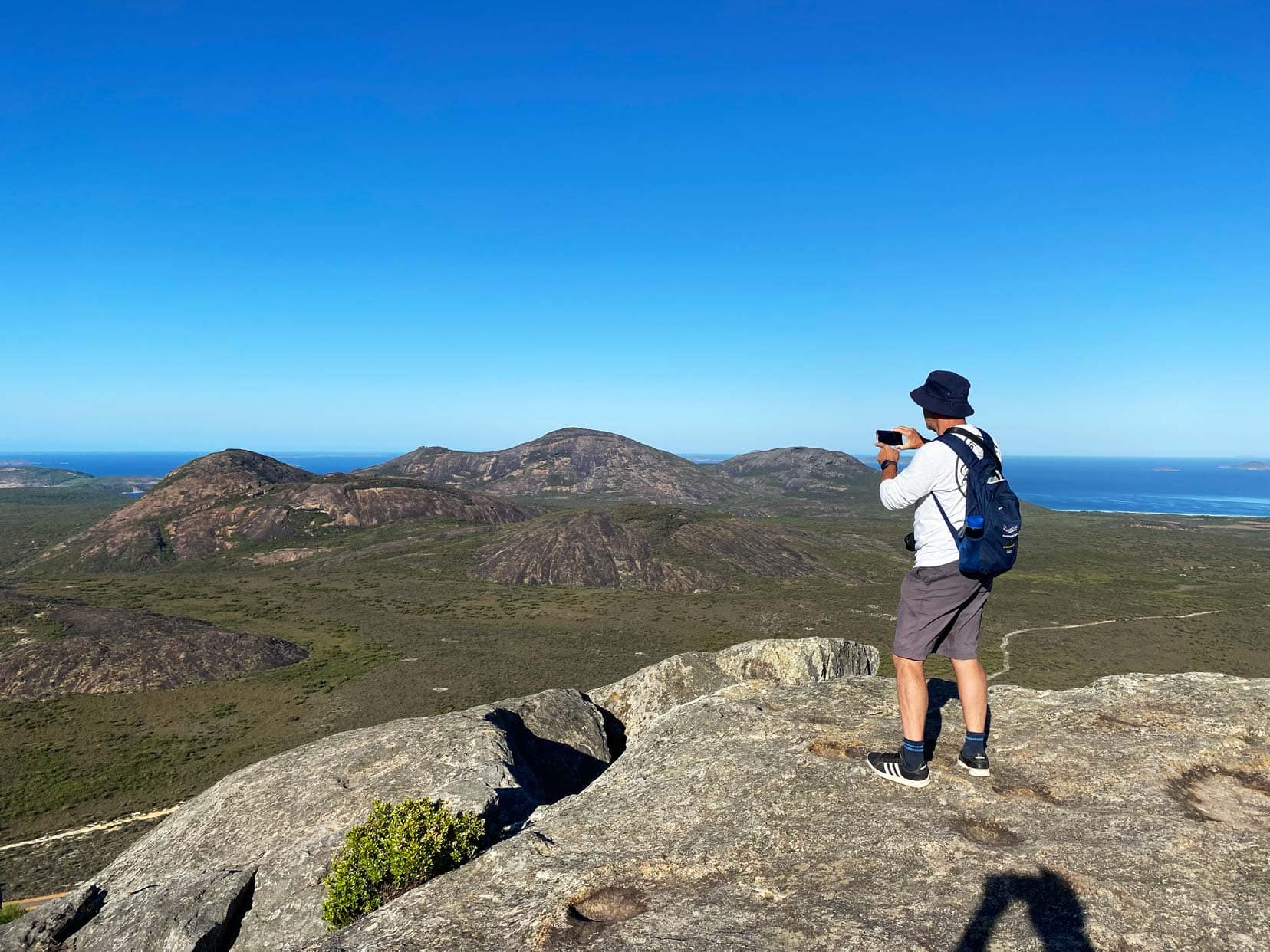 Lars stood on a mountain with views across Cape Le Grande to the Ocean 