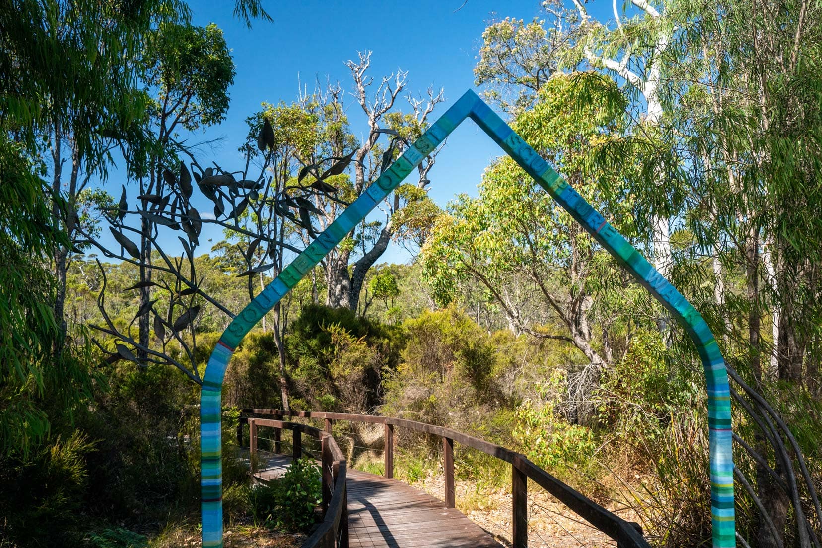 blue triangular shaped arch making the entrance to the Understory Art Trail 