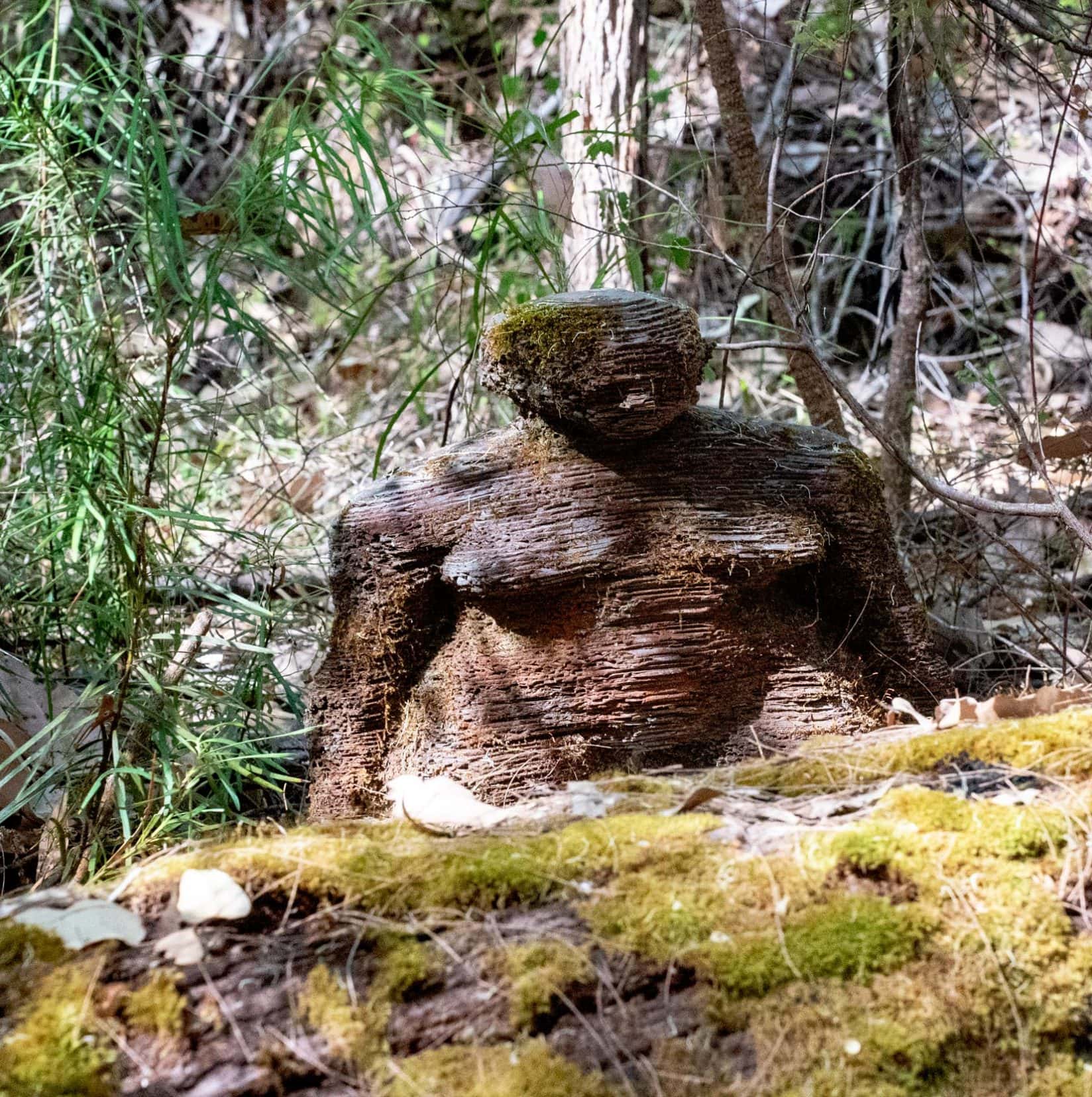 Bronze coloured figure that looks like it is made of layers 