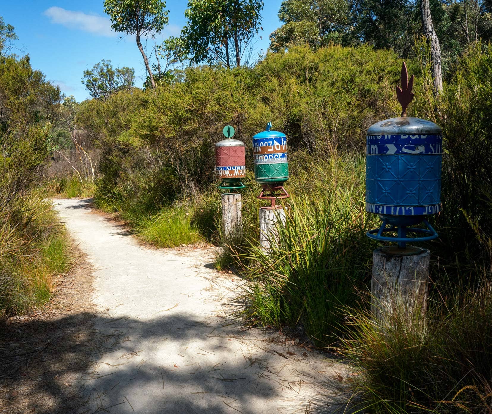 Northcliff-Understory-art-Trail-wishing-wheels - coloured barrel like designs that can be turned 