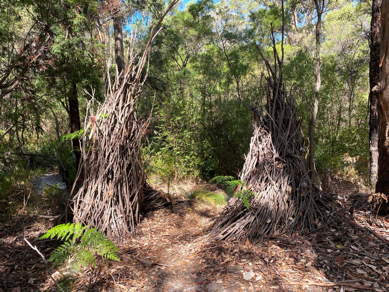 Two sets of stick columns leaning towards each other