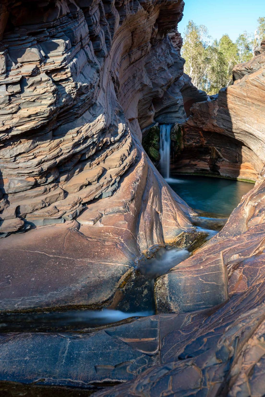 Hammersley Gorge Spa Pool a small enclosed area with a small waterfall flowing into the pool 