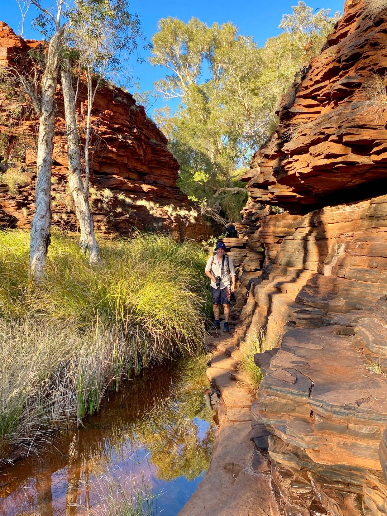 Lars walking through Kalamina Gorge with high gorge walls close by 